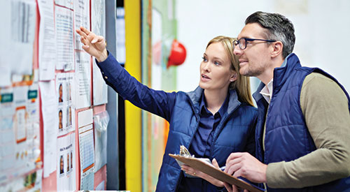 Field workers looking at bulletin board