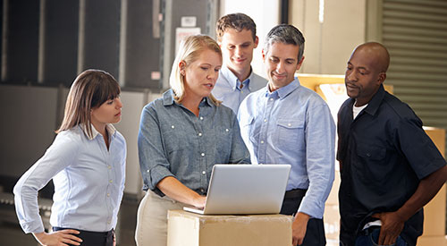 Team members looking at computer